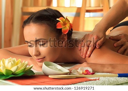 Beautiful young woman taking spa treatments at the salon.