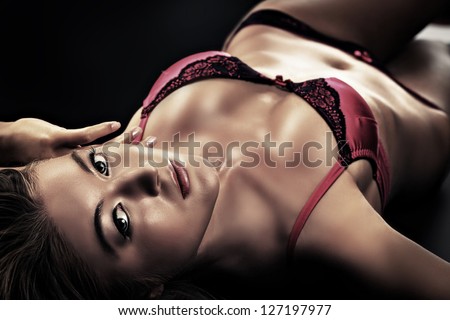 Portrait of a sexual woman in lingerie over black background.