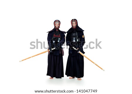 Two kendo fighters posing together over white background. Asian martial arts.