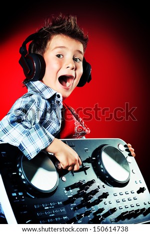 Expressive little boy DJ in headphones mixing up some party music.