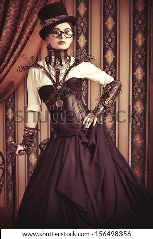 Full length portrait of a beautiful steampunk woman over vintage background.