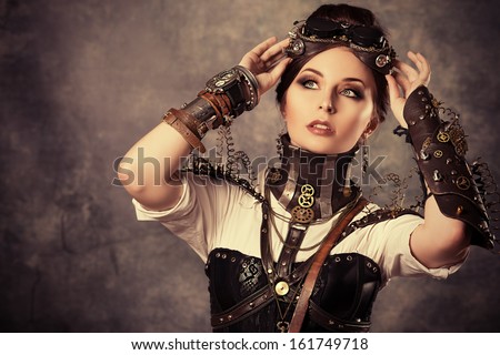 Portrait of a beautiful steampunk woman over grunge background.