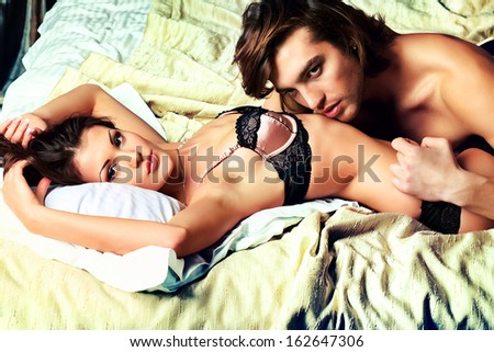Sexy young couple playing in love games in a bedroom.