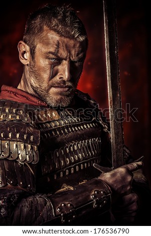 Portrait of a courageous ancient warrior in armour with sword.