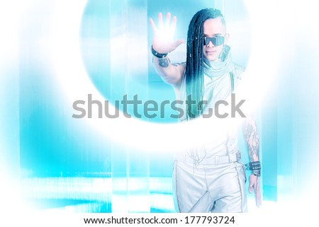 Portrait of the eccentric futuristic man in silver costume. Innovations and high technology. Rock artist.