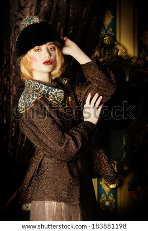 Portrait of a beautiful fashion model in a rich historical costume. Fur clothing. Vintage. Luxury style.
