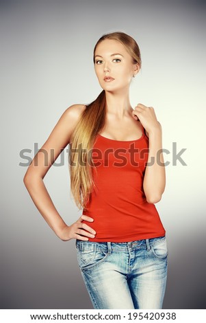 Portrait of a young slender woman wearing jeans.