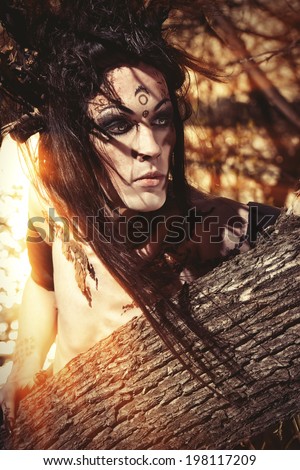 Close-up portrait of a fantasy man in a wild wood. Art project. Fantasy. Halloween.