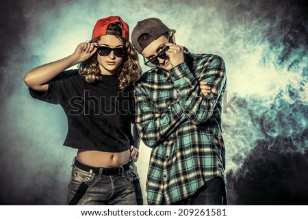 Two modern dancers over grunge background. Hip-hop. Urban, disco style.