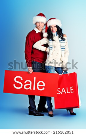 Full length portrait of a happy young people standing with a lot of shopping bags. Sale.