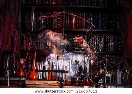 Crazy old man medieval scientist working in his laboratory. Alchemist. Halloween.