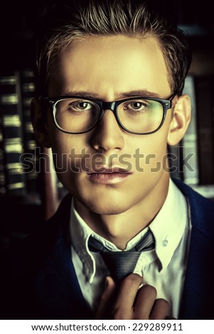Close-up portrait of a respectable handsome man in his cabinet, library. Classic vintage style.