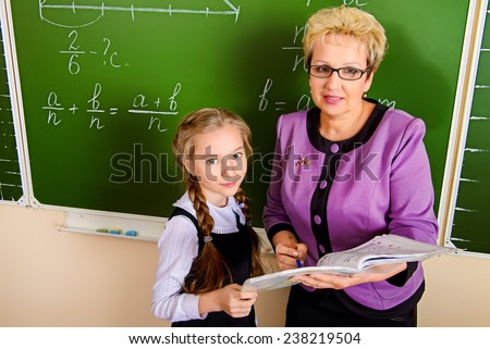 A teacher and her student during class at school. Education.