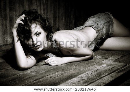 Stunning sensual nude woman. Fashion, beauty and love concept. Jeans style. Black-and-white portrait.
