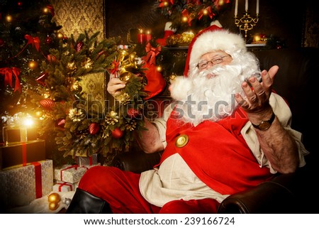 Santa Claus sitting at home with gifts, dressed in his home clothes. Christmas. Decoration.