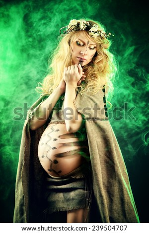 Portrait of a primeval pregnant woman. Ancient times. Fantasy.