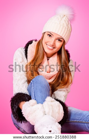 Joyful girl in warm knitted clothing smiling at camera. Beauty, fashion. Winter lifestyle.