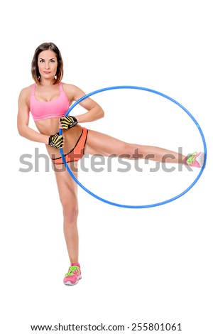 Beautiful athletic woman posing with hula hoop. Fitness sports. Healthcare, bodycare.