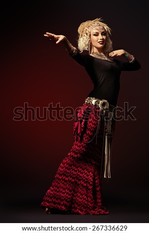Studio shot of a beautiful traditional female dancer. Ethnic dance. Belly dancing. Tribal dancing.