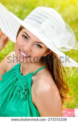 Portrait of romantic young woman with beautiful smile outdoors. Summer day.