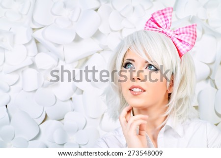 Close-up portrait of a lovely girl wearing white wig and white blouse posing over  background with paper flowers. Anime style.