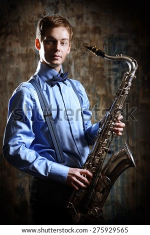 Portrait of a musician with his saxophone. Art and music. Jazz music.
