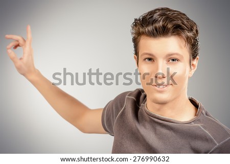 Portrait of a handsome young man explaining something and gesturing with his hands. Businessman. Men's beauty, fashion.