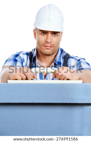 Male builder in working clothes, helmet and tools. Isolated over white.