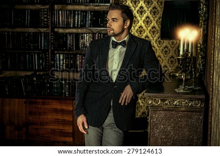 Handsome elegant young man in classic vintage apartments. Fashion. Luxury.