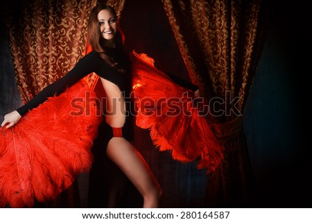 Beautiful dancer on the stage of cabaret. Performance. Beauty, fashion.