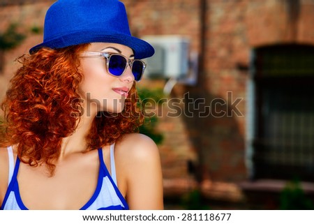 Attractive young woman beautiful foxy hair outdoors. Beauty, fashion.