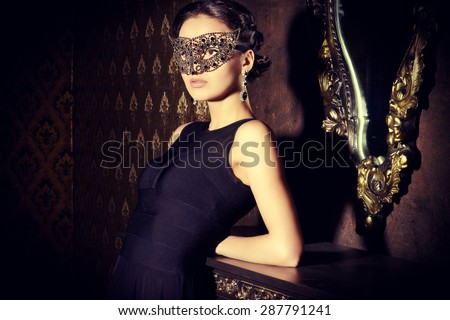Beautiful mysterious stranger girl in venetian mask. Carnival, masquerade. Jewellery, gems.
