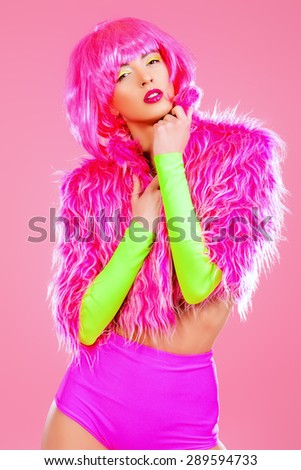 Pretty girl posing in sexy colourful clothes. Make-up, cosmetics. Bright fashion. Pin-up, pink style. Studio shot.