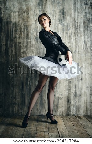 Portrait of a modern ballet dancer posing at studio over grunge background. Art concept.