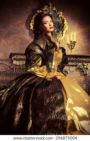 Renaissance Style -  beautiful young woman in the lush expensive dress in an old palace interior. Vintage style. Fashion.