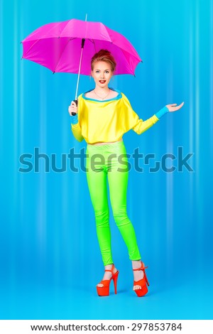 Fashionable young woman alluring in vivid colourful clothes and high heels platform shoes. Bright fashion. Pin-up style. Full length portrait.