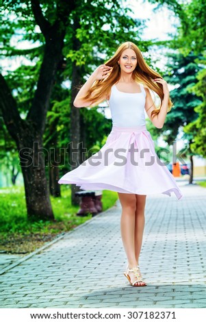 Happy beautiful young woman in light summer clothes enjoying sunny summer day. Beauty, fashion.