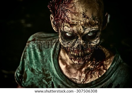 Close-up portrait of a horrible scary zombie man. Horror. Halloween.