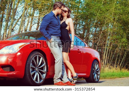 Beautiful couple near the car. Beauty, fashion. Love concept.