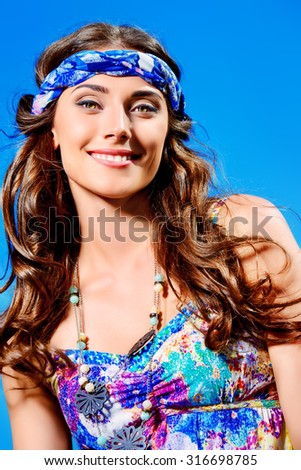 Romantic hippie girl standing outdoor in the summer day over blue sky background. Hippie style. Child of nature.