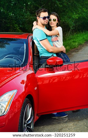 Romantic couple in love embracing near the car. Beauty, fashion. Love concept.