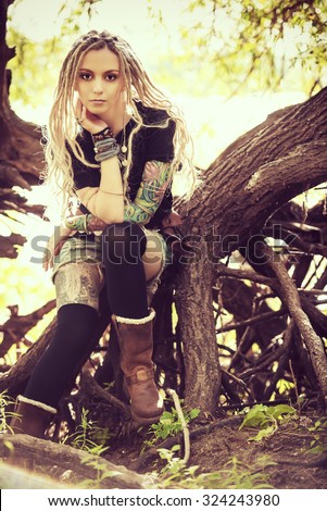 Attractive boho style girl in the wild wood. Boho, hippie fashion shot.