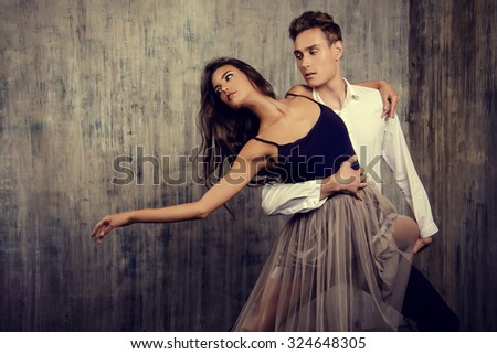 Beautiful couple of ballet dancers dancing over grunge background. Beauty, fashion.