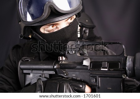 Shot of a soldier holding gun. Uniform conforms to special services(soldiers) of the NATO countries. Shot in studio. Isolated with clipping path.