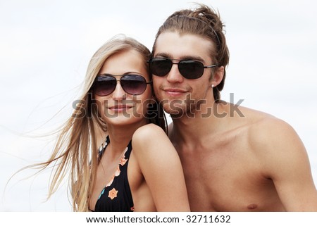 Couple of young people having a rest on a beach. Great summer holidays.