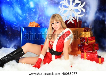 Portrait of a sexy young woman wearing christmas clothes over sky of stars and snow.