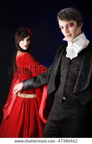 Portrait of a beautiful couple in medieval costumes with vampire style ...