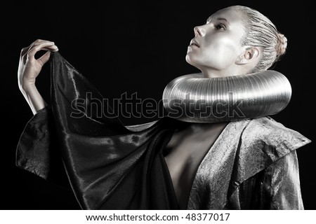Portrait of an artistic woman painted in metal style. Shot in a studio.