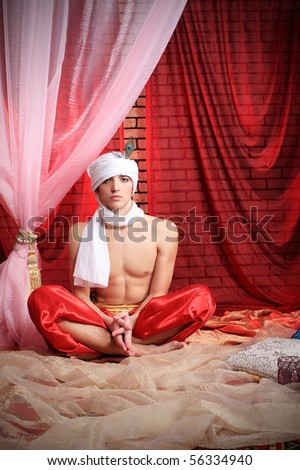 Shot of a man in oriental costume having a rest .