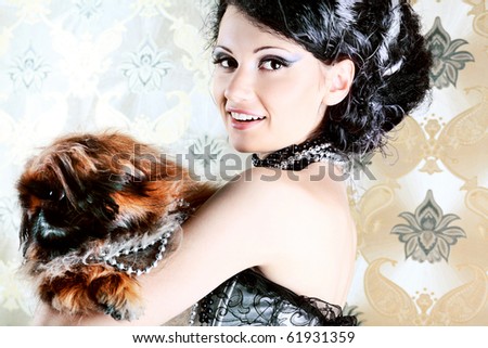 Portrait of a fashionable lady with a dog over vintage background.